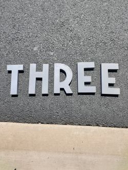 Metal letters spell three 3
