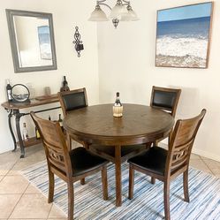 This is a beautiful dining room set with 4 cushioned chairs. The table top is in fair condition and has a removable base for easy transport. All 4 cha