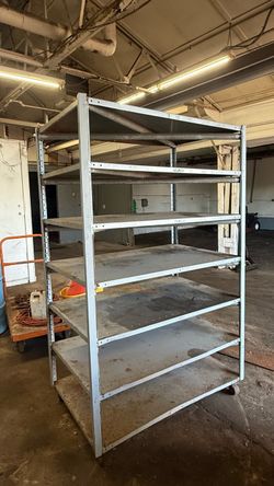 Wheeled organizer welded solid steel with shelves one foot spaced.6ft heigh,4ft in length by30”width