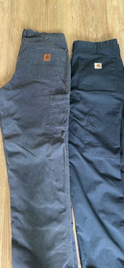 Two Carhartt pants with utility packet