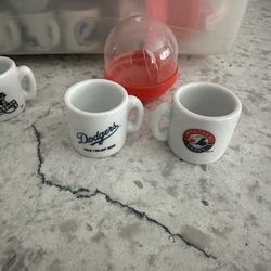 Miniature porcelain Football & Baseball mugs.￼