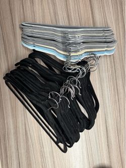 70 wooden hangers and 60 velvet hangers