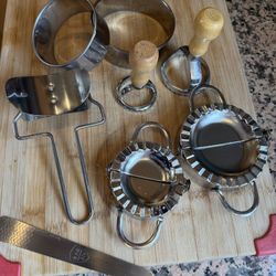 Set of stainless steel kitchen tools in good condition.
