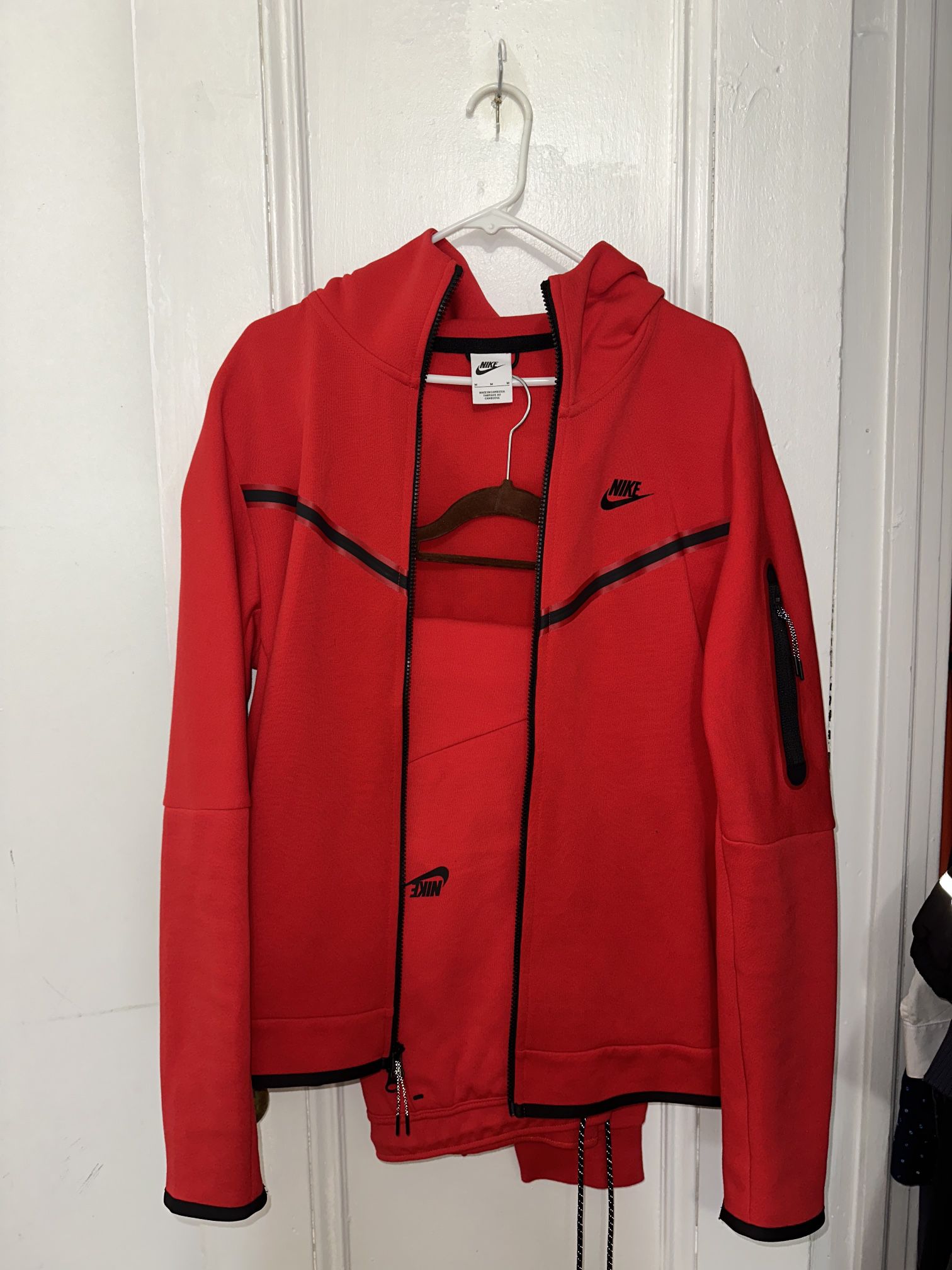 Red Nike tech suit 
