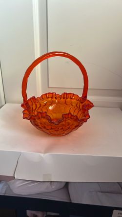 vintage Fenton orange glass basket with a ruffled edge and handle,