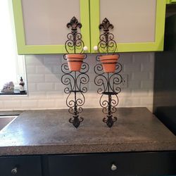 2 wall hanging metal plant stands. Can put small plants or candle on shelf underneath pots. 