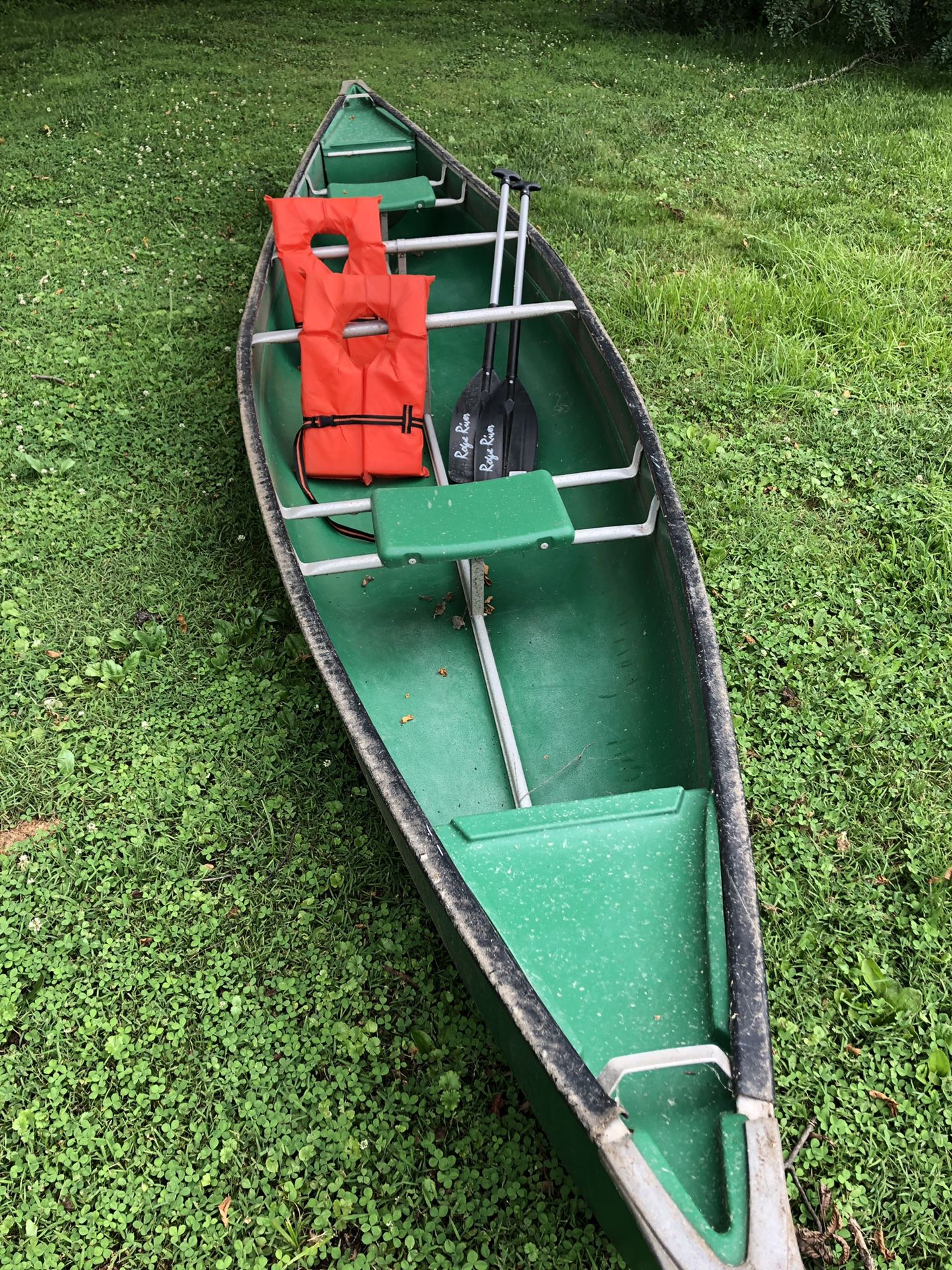 Green Canoe with 2 oars and 2 life vest
