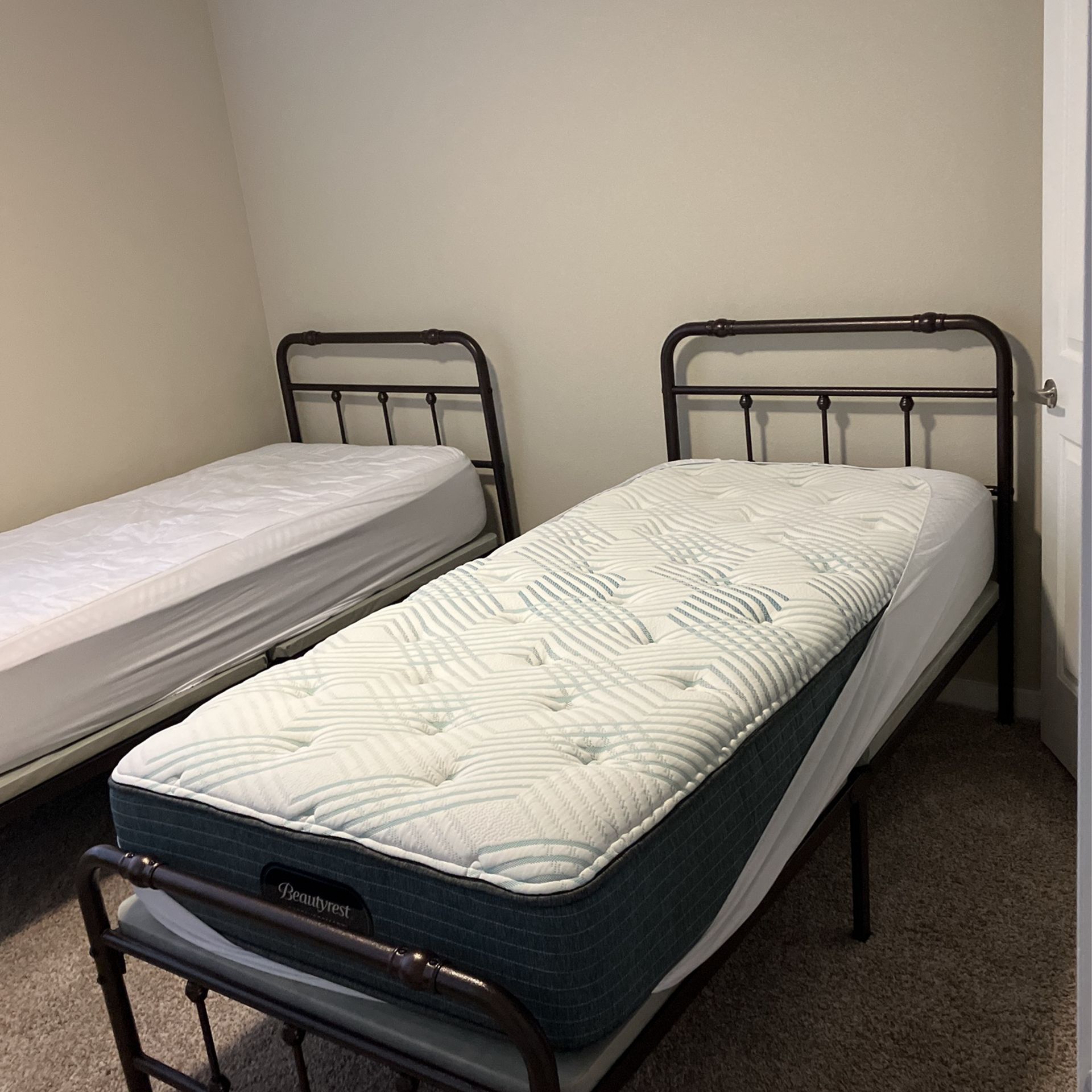 Two Twin XL Bed frames With Attached Bunkie Boards And Mattresses for