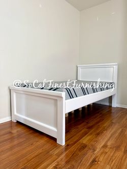 White twin bed with mattress