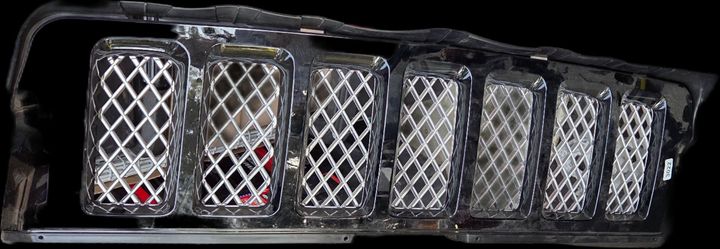 black and chrome mesh front grille assembly with seven vertical slots, matching a 2008–2009 or 2011–2013 Jeep Grand Cherokee Overland model.