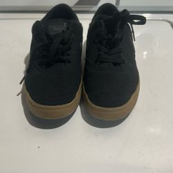 black canvas Nike SB Check Canvas kids' skate shoes with a gum rubber outsole. 