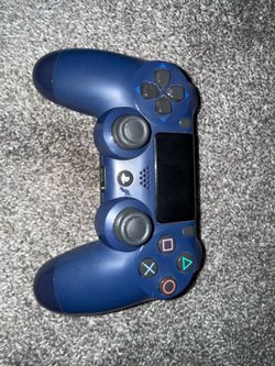 Red, blue, and black ps4 controller with charging dock