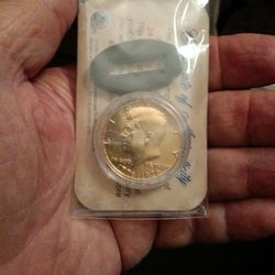 In Package, Golden Kennedy Bicentenial Half Dollar, With COA, And Coin Stand.