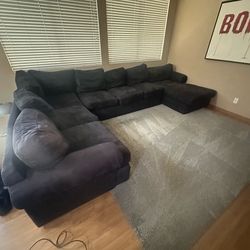 Huge microsuede microfiber sectional couch and gray area rug