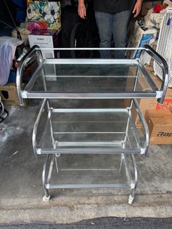 Cart with glass shelves on wheels