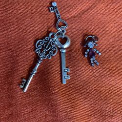 2 beautiful pendants: Set of 3 keys + little Bling person. Silver tone, glass Or Crystal.