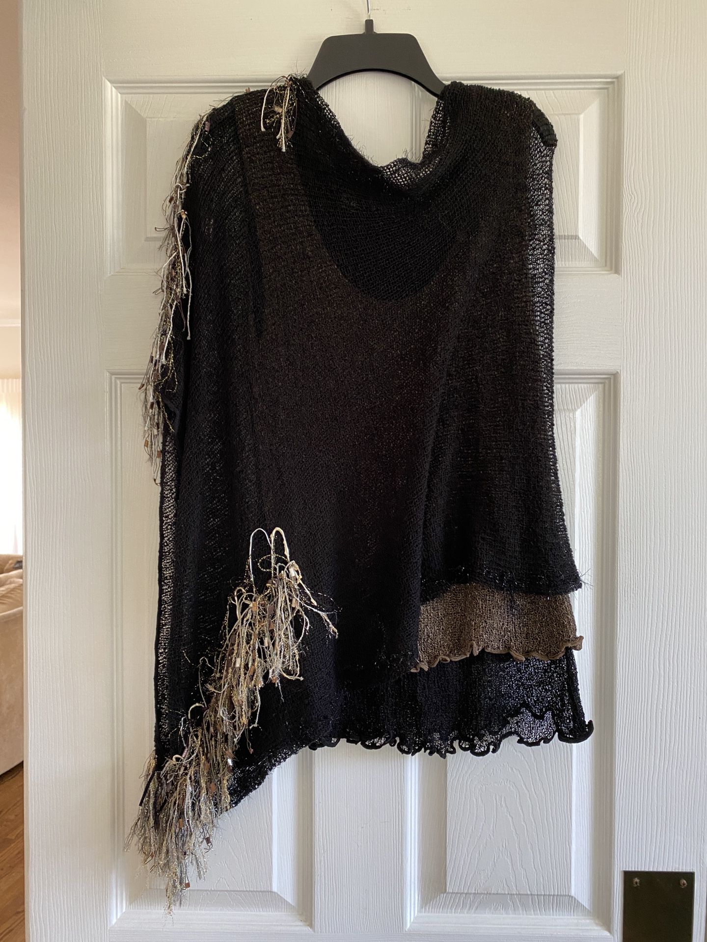 Two piece handmade knit tank-top and poncho set, tank top is reversible to black or taupe. The poncho has embellishments in gold, taupe and white yarn