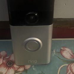 Used Ring camera with wall plate and charger cord 35 firm upgraded can wire to door bell or remove to charge