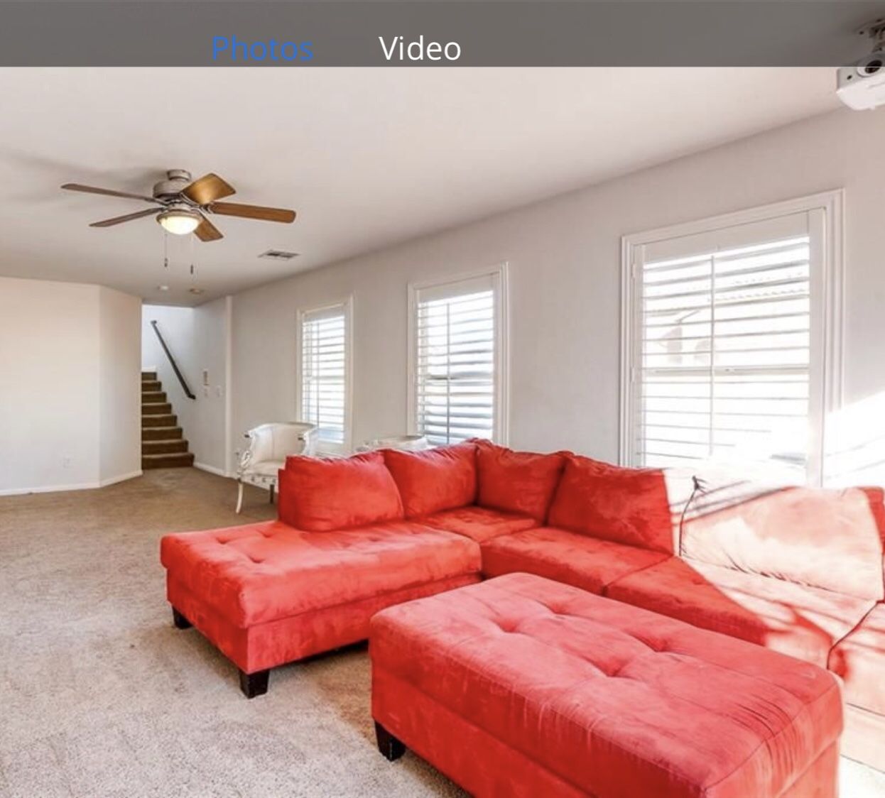 Red microfiber chaise lounge sectional sofa and ottoman combo.