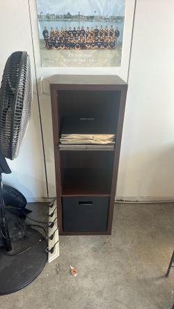 Brown shelf with 3 storage areas and fold out boxes.