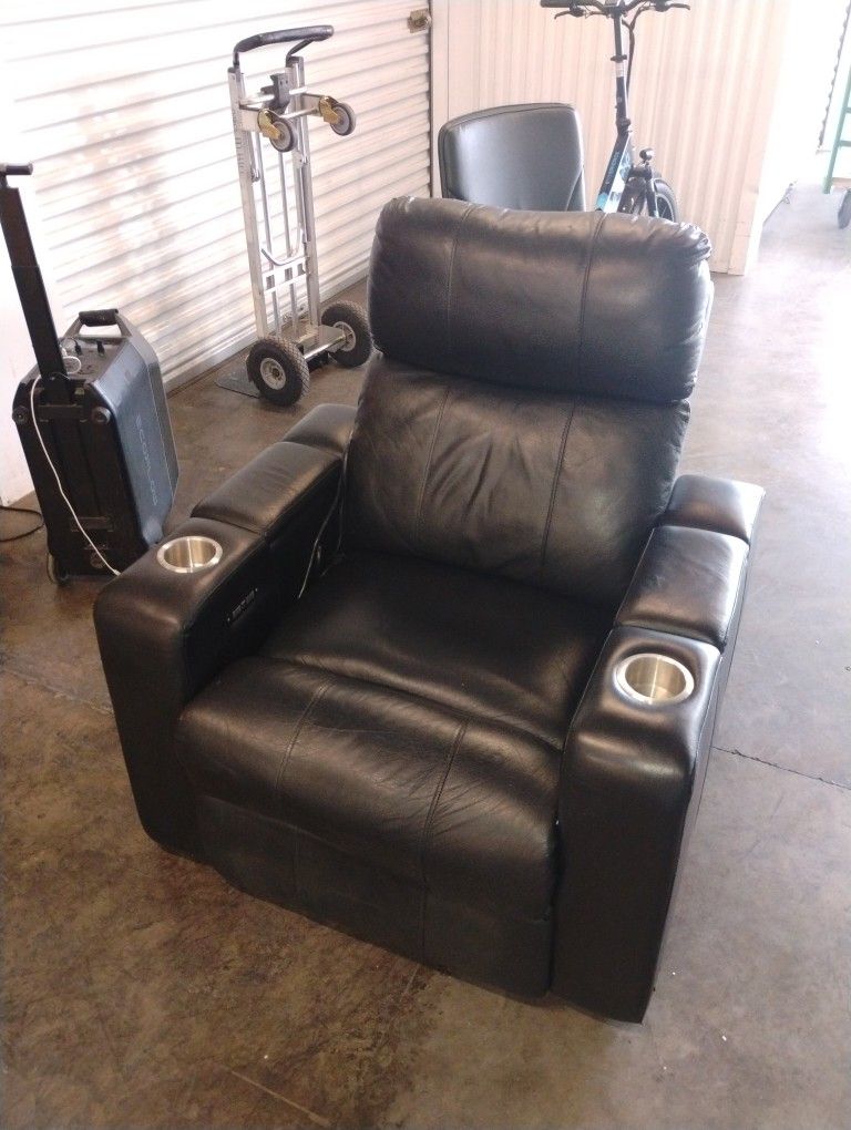 Black Leather Power Recliner With Power Headrest And Charging Ports.