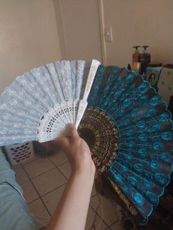 2 peacock styled hand held fans