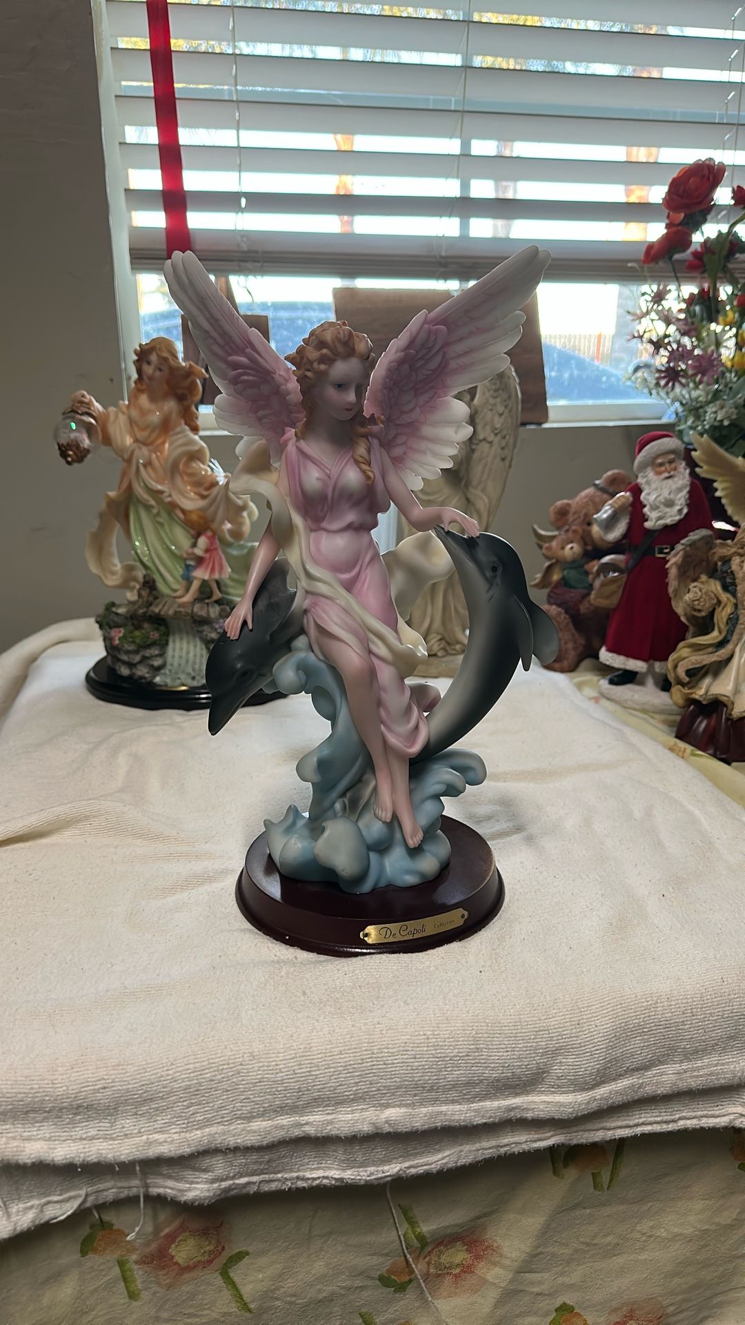 Pink Angel Sitting With Dolphins