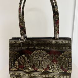 New colorful small fabric handbag with elephants purchased in Thailand. Colors include black, gold and an orangey-red. Purse has 2 zippered pockets. B