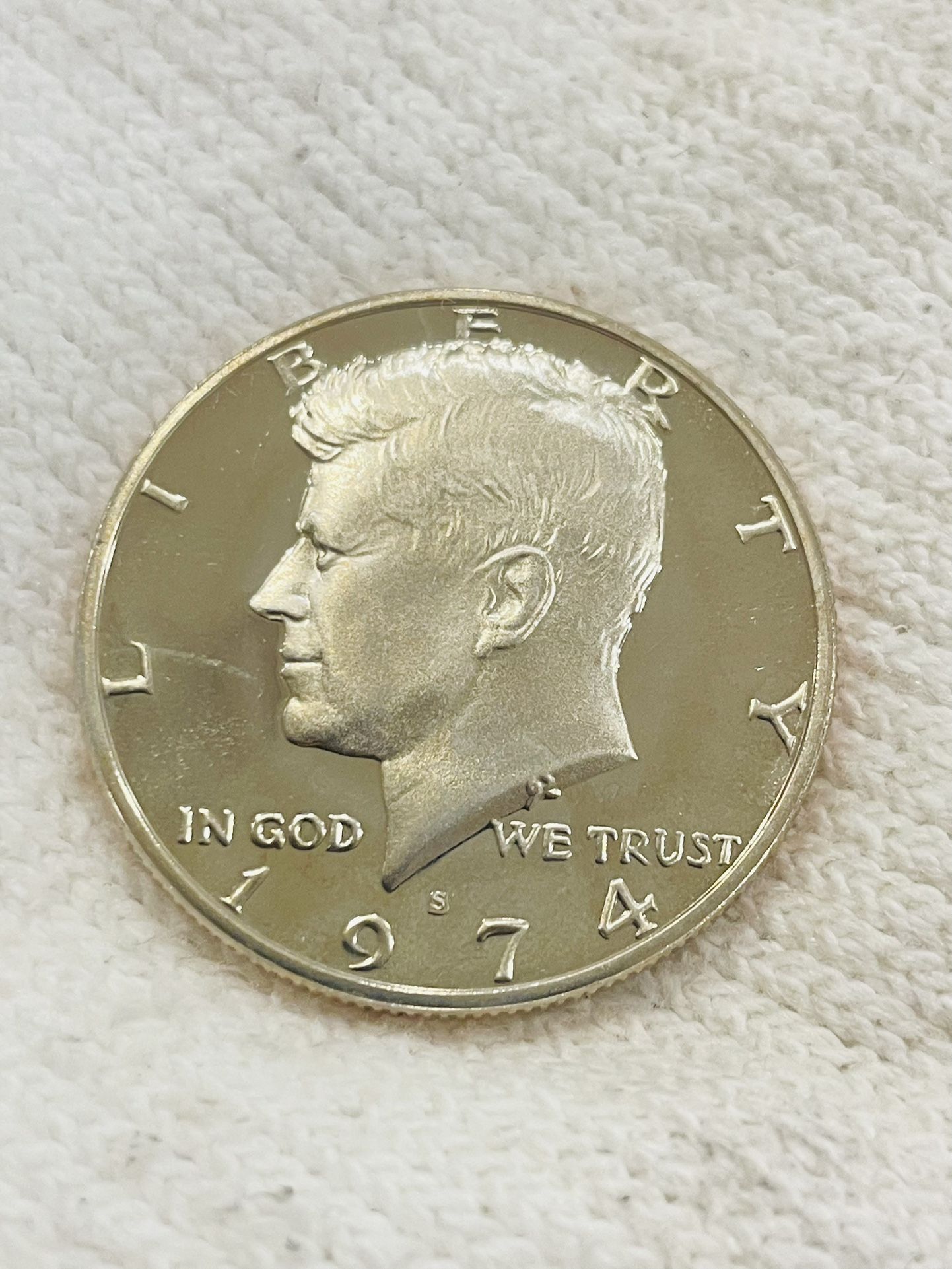 This set includes Two 1974 Proof Jfk Half Dollars And Two 2022 almost uncirculated JFK half dollars