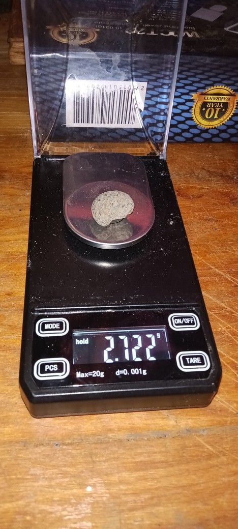 Small Meteorite Magnetic And Weighs. 2.722 In A Scale