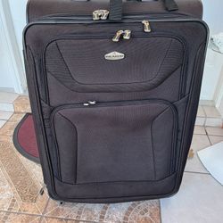 Large suitcase in good condition and clean, measuring 29 inches high, 20 inches wide, and 12 inches deep.