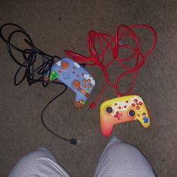 Two Wired Nintendo Switch Controllers Pikachu and Old School Super Mario Bros.