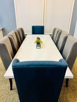 Contemporary rectangular white dining table with 8 upholstered dining chairs