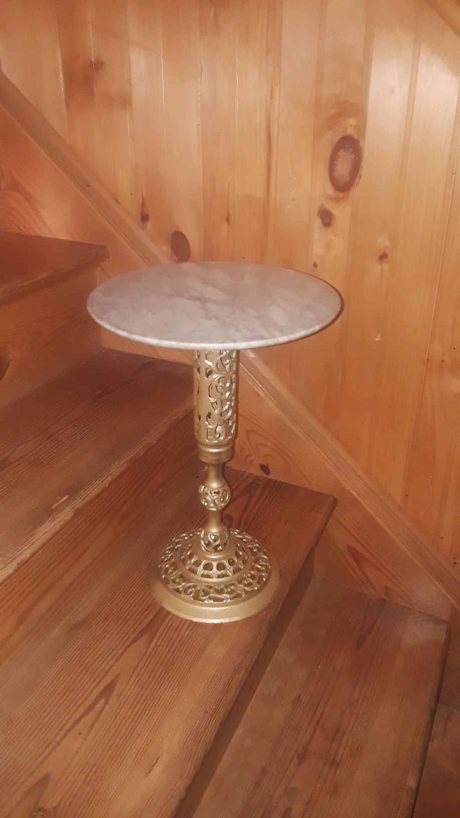 A small table on bronze stand. Marble top and sprinnig