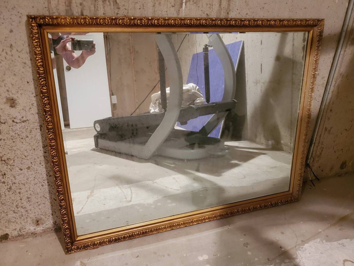 Beautiful Beveled edged mirror with beautiful ornate gold wood frame.