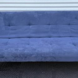 blue sleeper sofa or futon. This model is designed to be a versatile and space-saving piece of furniture that easily converts from a sofa to a