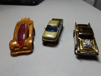 3 golden toy cars