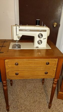Sears kenmore sewing machine, with attachments.