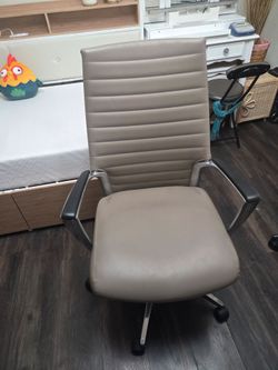 This is a high-back, ribbed office chair.
