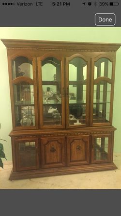 2 piece oak China hutch, 8 doors open, top and bottom lighted, glass shelves