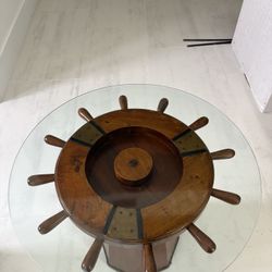 Nautical ship wheel glass-top table.