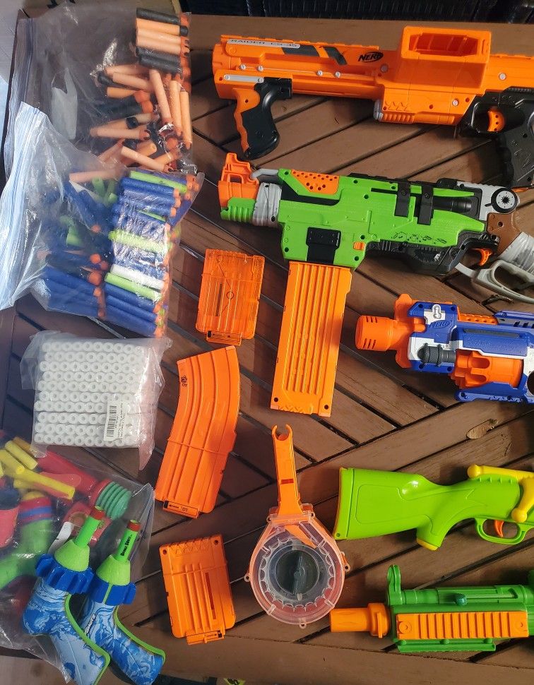Assortment Of Nerf Guns, Water Guns, And Water Balloons