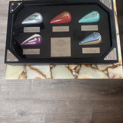 displays a collectible shadow box set of Harley-Davidson miniature gas tanks. These sets were often released as limited editions, sometimes as holiday