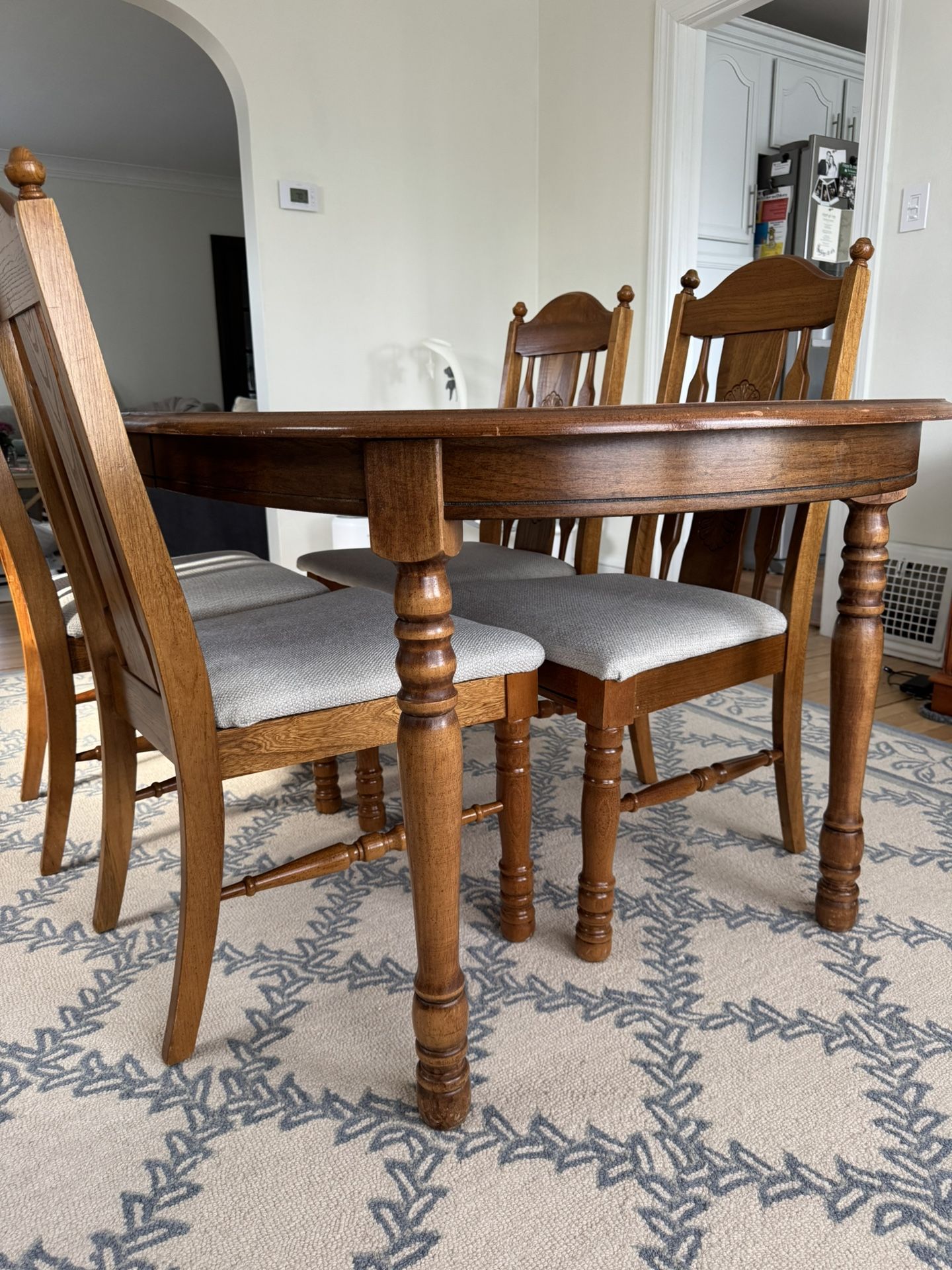 Elegant Solid Wood Dining Table with Carved Legs & Chair Detail