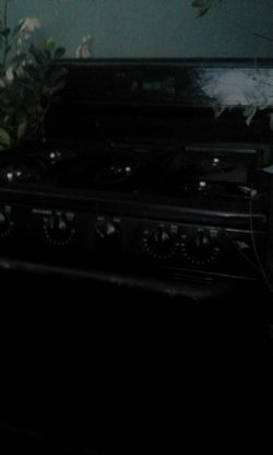 GE gas range oven cut the center burner with flat with a hot plate all black in new condition I was told you have to light with a match