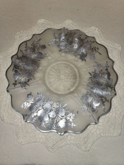This is a SILVER CITY glass bowl/platter  in the blossom time pattern,  featuring a distinctive scalloped edge  & stearling silver floral overlay.
