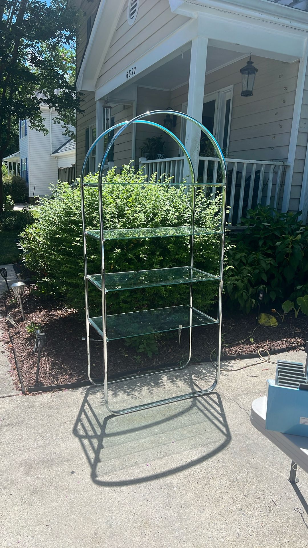 Silver display stand with four glass shelves