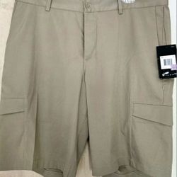 Pair of Nike Dri-FIT men's golf cargo shorts in beige/khaki.  Men's 34