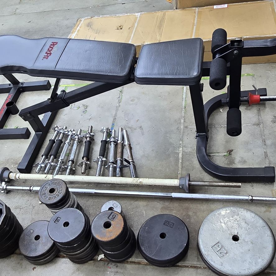 Rockfit Weight bench and 651lbs of standard weights with weight tree with barbells