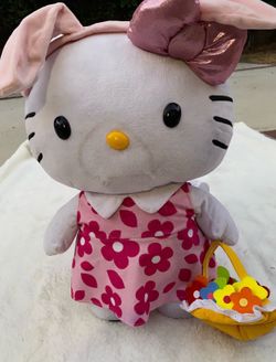 Large Hello Kitty plush wearing pink floral dress with flower basket.